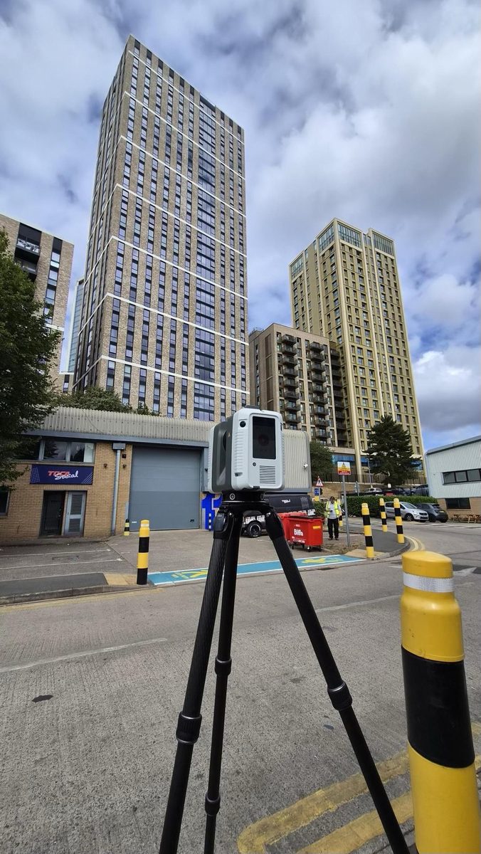 Laser scanner set up beside purpose-built student accommodation towers