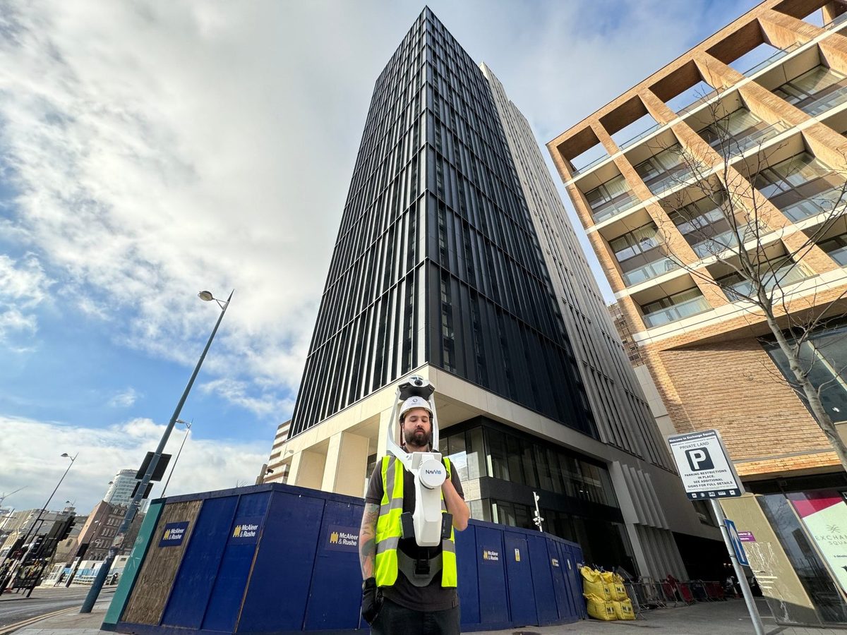 Spacion surveyor capturing a residential tower with a NavVis wearable laser scanner